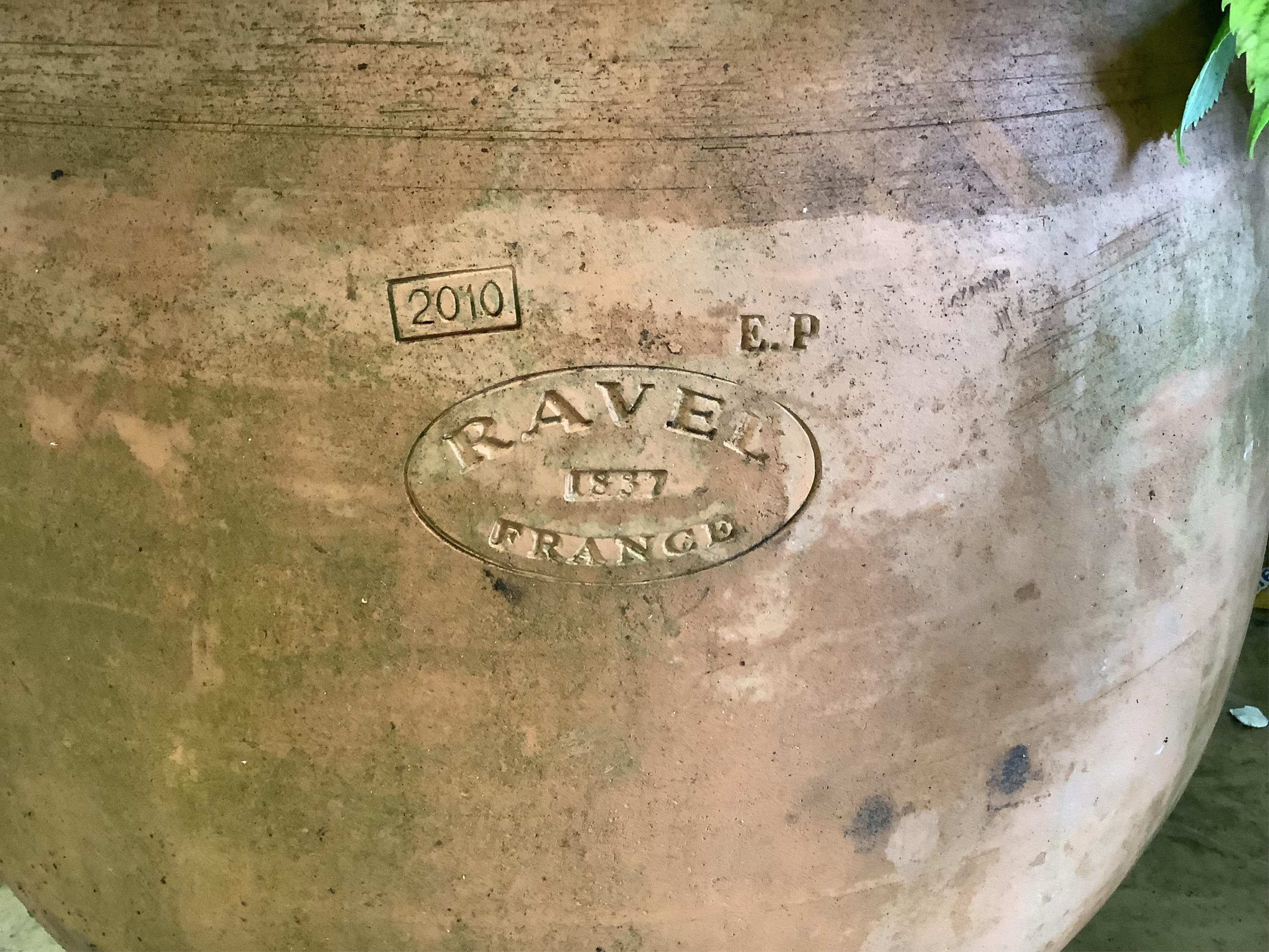A pair of circular terracotta garden planters, stamped Ravel, France, diameter 45cm, height 40cm